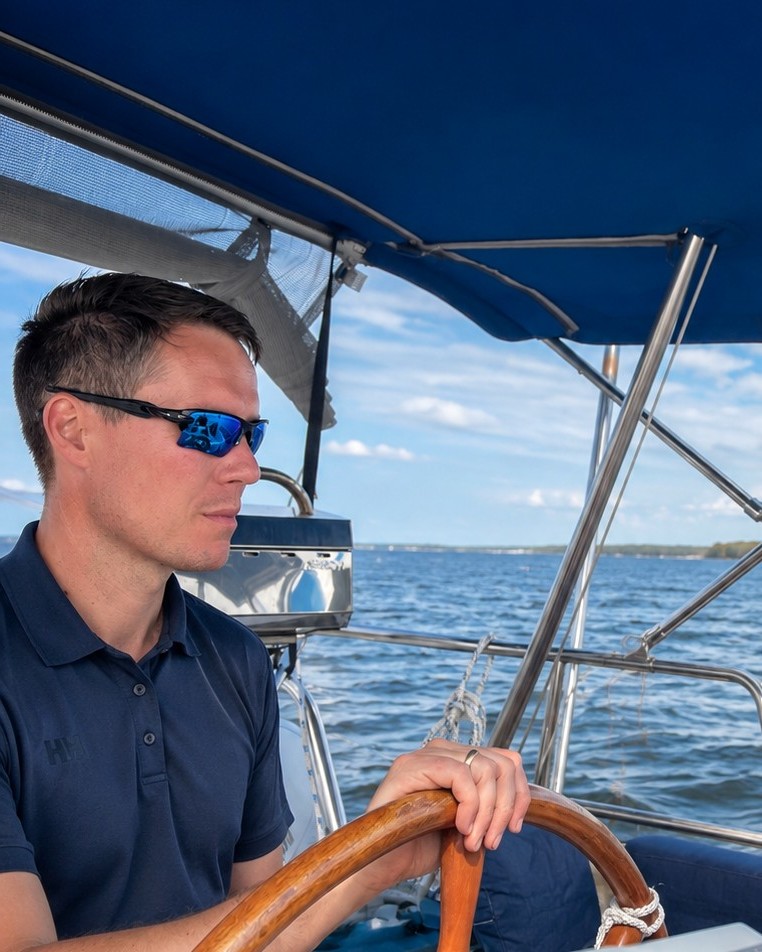 Sean Doyle at the helm of a sailboat on the Chesapeake Bay